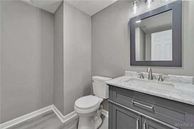 14 Gloucester Cir, Petersburg, VA 23803 - bathroom with baseboards, vanity, toilet, and wood finished floors
