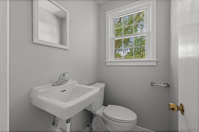bathroom with toilet and baseboards