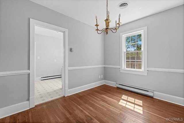 empty room featuring a baseboard heating unit, a baseboard radiator, a chandelier, and wood finished floors