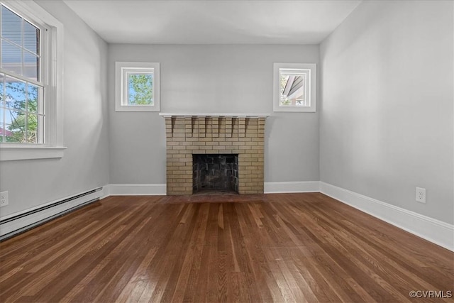unfurnished living room featuring wood-type flooring, a brick fireplace, baseboards, and a baseboard radiator