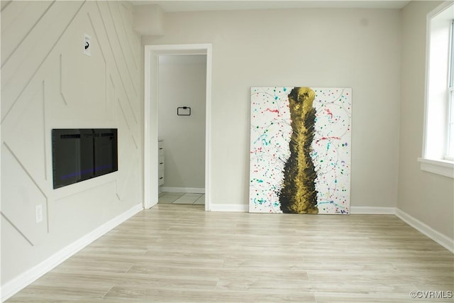 25 N Foley St, Petersburg, VA 23803 - unfurnished living room with light wood-type flooring and baseboards