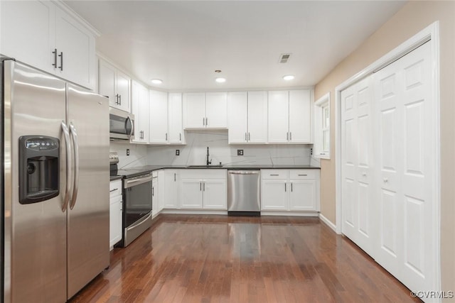 6006 Meadwood Cir, North Chesterfield, VA 23234 - kitchen featuring appliances with stainless steel finishes, a sink, dark countertops, white cabinets, and dark wood finished floors