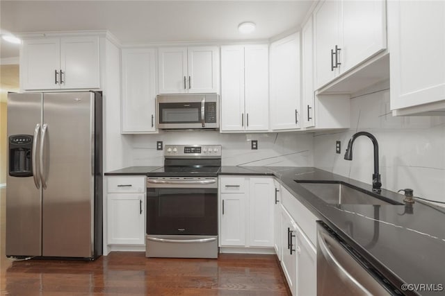 6006 Meadwood Cir, North Chesterfield, VA 23234 - kitchen featuring appliances with stainless steel finishes, white cabinets, dark wood finished floors, dark countertops, and tasteful backsplash