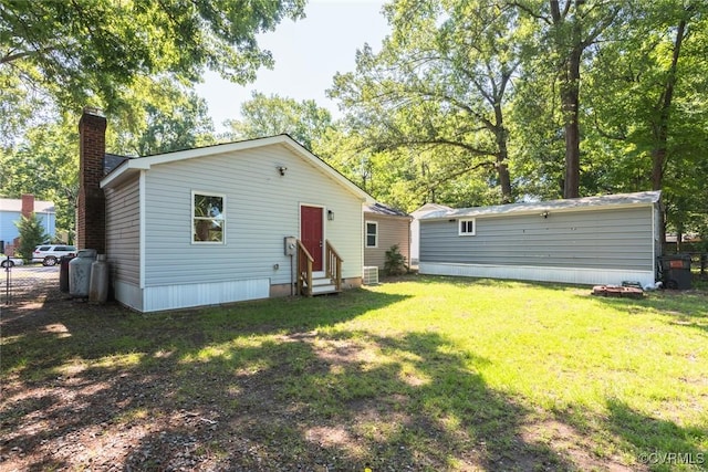 6006 Meadwood Cir, North Chesterfield, VA 23234 - rear view of house featuring entry steps, a chimney, and a yard