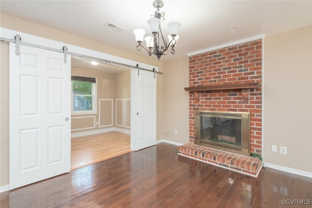 6006 Meadwood Cir, North Chesterfield, VA 23234 - unfurnished living room with a barn door, wood finished floors, a chandelier, baseboards, and a fireplace