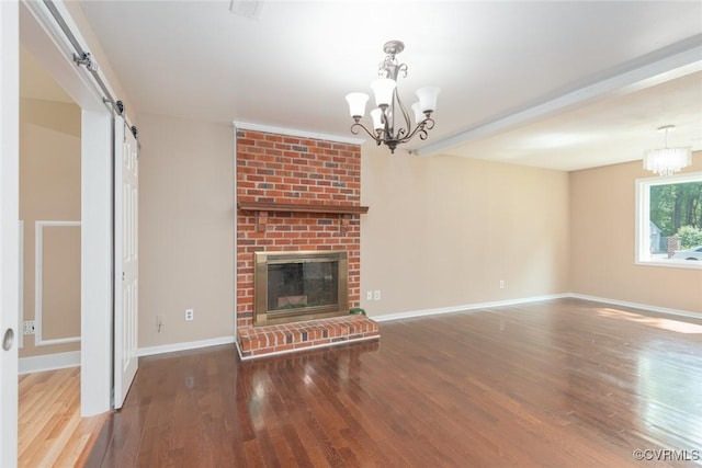 6006 Meadwood Cir, North Chesterfield, VA 23234 - unfurnished living room featuring a chandelier, wood finished floors, baseboards, a barn door, and a fireplace