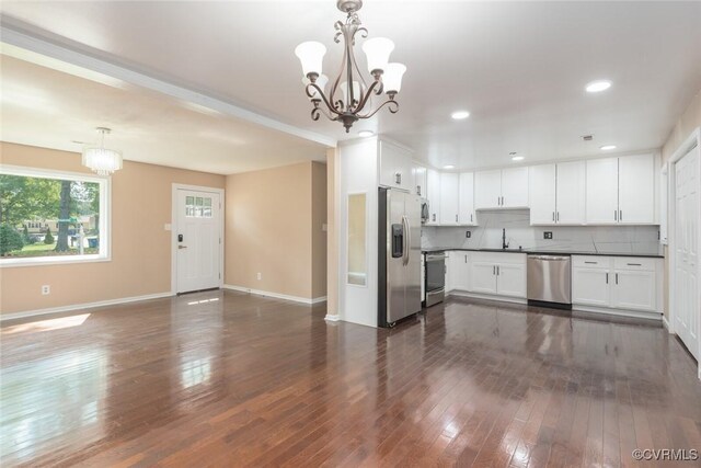 6006 Meadwood Cir, North Chesterfield, VA 23234 - kitchen featuring appliances with stainless steel finishes, a chandelier, dark countertops, open floor plan, and dark wood-style flooring