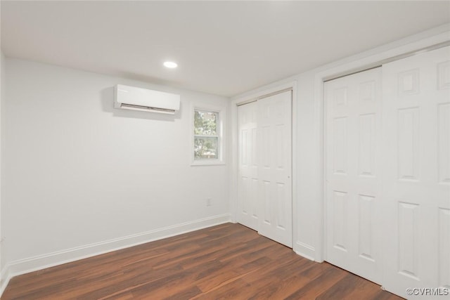 6006 Meadwood Cir, North Chesterfield, VA 23234 - unfurnished bedroom featuring a wall mounted air conditioner, two closets, baseboards, dark wood-style flooring, and recessed lighting