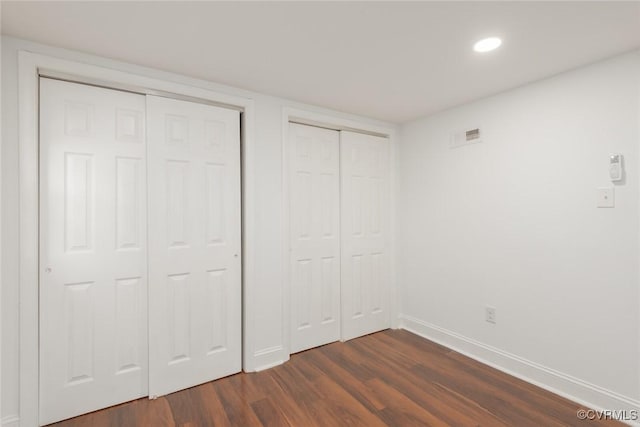 6006 Meadwood Cir, North Chesterfield, VA 23234 - unfurnished bedroom with dark wood finished floors, baseboards, multiple closets, and recessed lighting