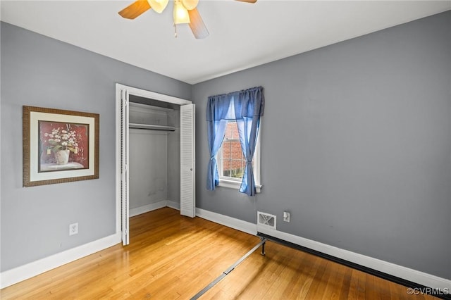 2405 Dumbarton Rd, Henrico, VA 23228 - unfurnished bedroom featuring baseboards, wood finished floors, a closet, and ceiling fan