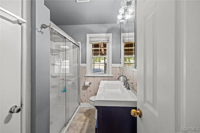 2405 Dumbarton Rd, Henrico, VA 23228 - full bathroom featuring toilet, a stall shower, a wainscoted wall, stone finish flooring, and vanity