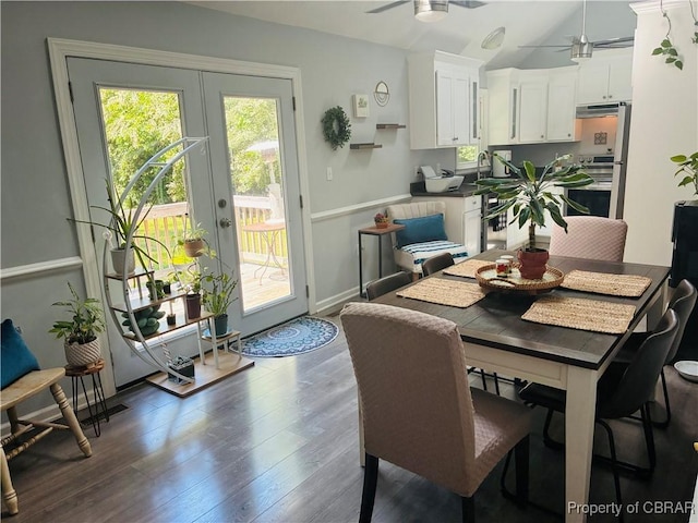 dining space featuring a ceiling fan, wood finished floors, french doors, vaulted ceiling, and baseboards