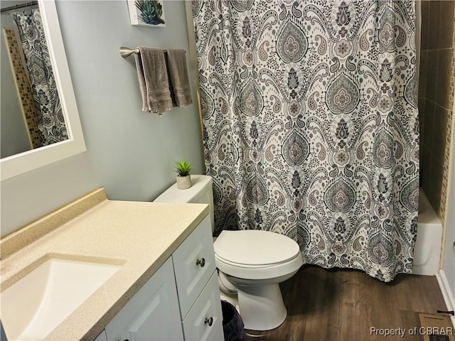 bathroom featuring wood finished floors, vanity, and toilet