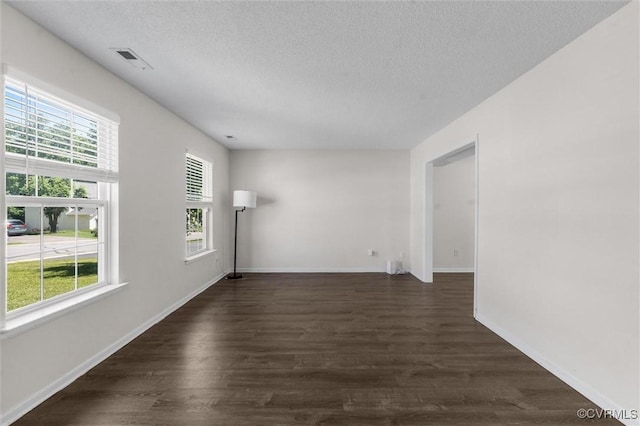 15119 Winding Ash Dr, Chesterfield, VA 23832 - unfurnished room featuring a textured ceiling, plenty of natural light, dark wood finished floors, and baseboards