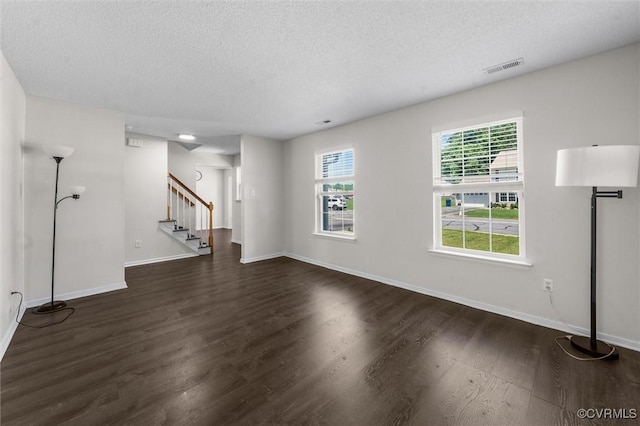 15119 Winding Ash Dr, Chesterfield, VA 23832 - unfurnished living room featuring a textured ceiling, stairway, dark wood-style flooring, and baseboards