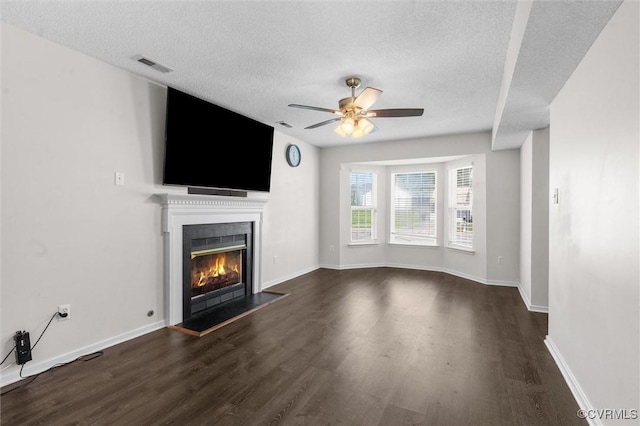 15119 Winding Ash Dr, Chesterfield, VA 23832 - unfurnished living room with dark wood-type flooring, a textured ceiling, a ceiling fan, a lit fireplace, and baseboards