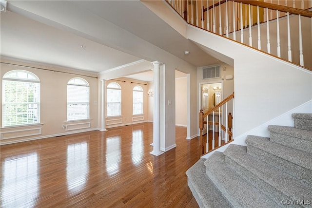 521 Siena Ln, Henrico, VA 23059 - staircase with healthy amount of natural light, decorative columns, and wood finished floors