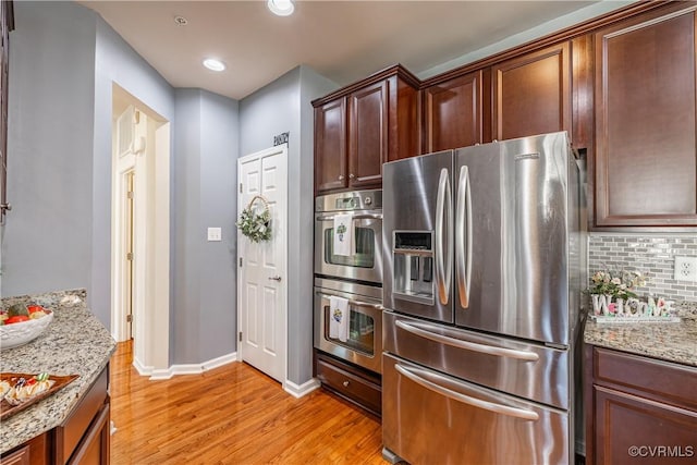 521 Siena Ln, Henrico, VA 23059 - kitchen with stainless steel appliances, light wood-style floors, backsplash, light stone counters, and recessed lighting