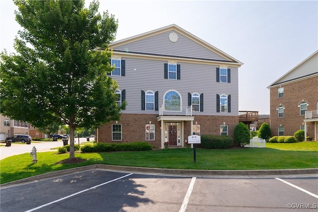 521 Siena Ln, Henrico, VA 23059 - view of front of house featuring brick siding, uncovered parking, and a front lawn