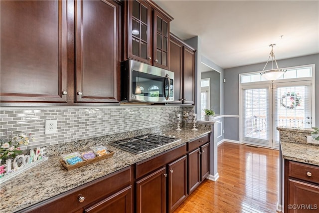 521 Siena Ln, Henrico, VA 23059 - kitchen with stainless steel appliances, light wood-style floors, decorative backsplash, light stone countertops, and pendant lighting
