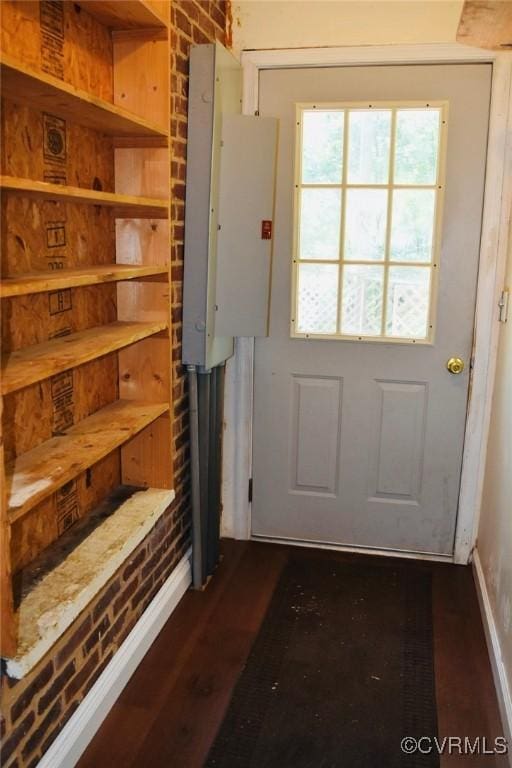 1006 N Main St, Farmville, VA 23901 - doorway with dark wood-style floors, brick wall, and electric panel