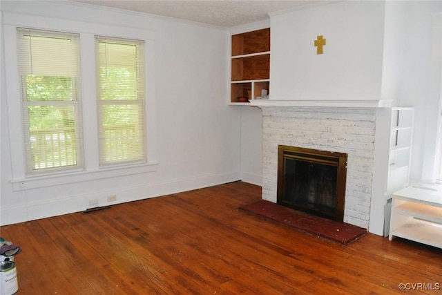 1006 N Main St, Farmville, VA 23901 - unfurnished living room with hardwood / wood-style floors, a fireplace, ornamental molding, built in features, and baseboards