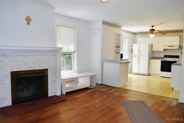 1006 N Main St, Farmville, VA 23901 - kitchen featuring electric stove, white fridge with ice dispenser, under cabinet range hood, light wood-type flooring, and white cabinetry