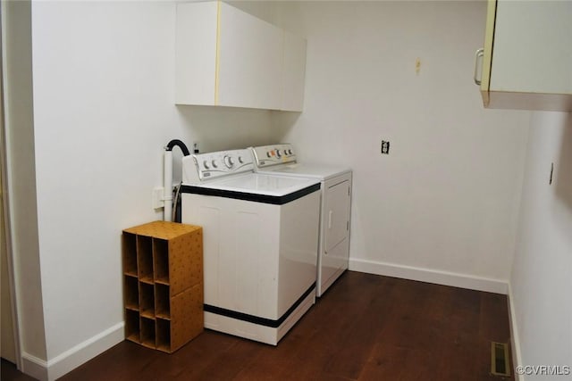 1006 N Main St, Farmville, VA 23901 - laundry area featuring washer and dryer, cabinet space, baseboards, and dark wood-type flooring