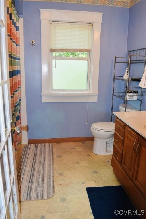 1006 N Main St, Farmville, VA 23901 - bathroom featuring toilet, baseboards, vanity, tile patterned floors, and curtained shower