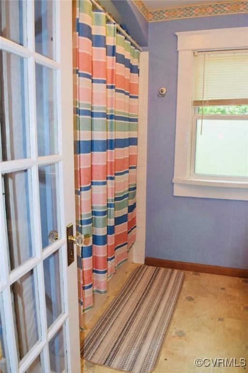 1006 N Main St, Farmville, VA 23901 - bathroom with baseboards and a shower with shower curtain