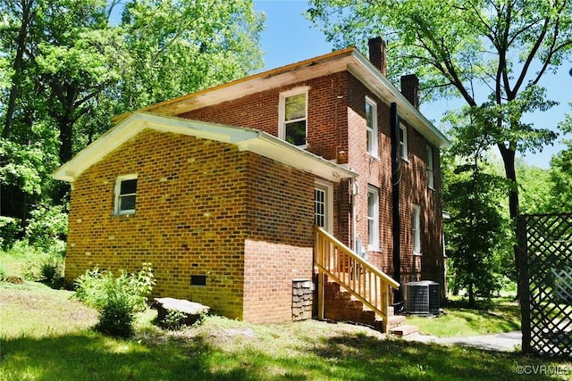 1006 N Main St, Farmville, VA 23901 - view of home's exterior with brick siding, a chimney, and central AC unit