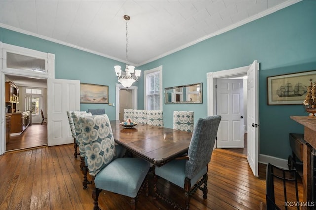 102 Market St, Onancock, VA 23417 - dining space with hardwood / wood-style floors, a chandelier, crown molding, and baseboards