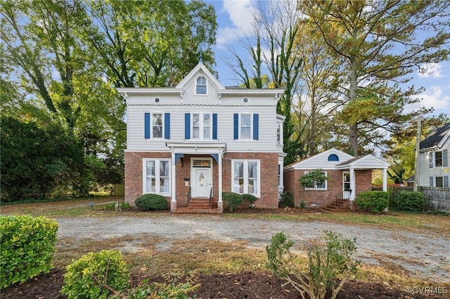 102 Market St, Onancock, VA 23417 - view of front of house featuring brick siding, board and batten siding, and fence