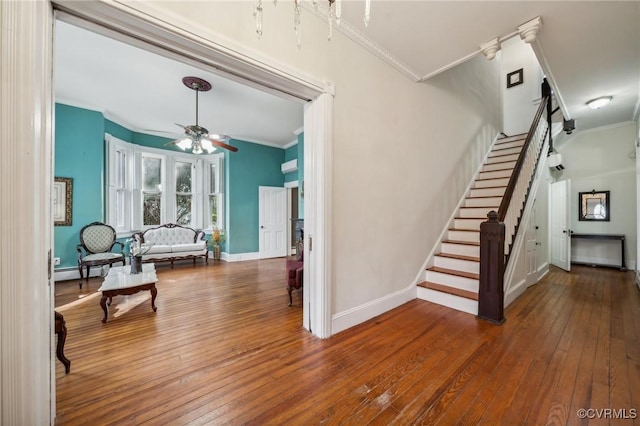 102 Market St, Onancock, VA 23417 - stairway featuring crown molding, a ceiling fan, wood-type flooring, and baseboards