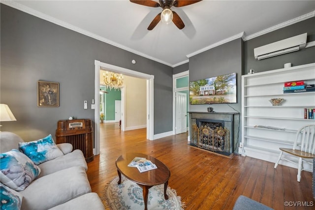 102 Market St, Onancock, VA 23417 - living area featuring an AC wall unit, a fireplace, ceiling fan, wood finished floors, and a chandelier