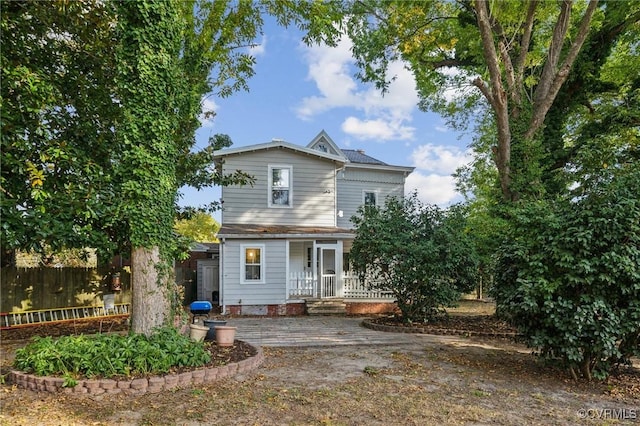 102 Market St, Onancock, VA 23417 - view of front facade with a porch and fence