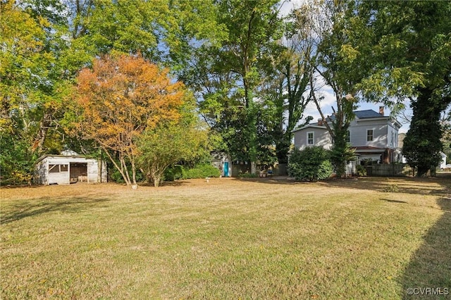 102 Market St, Onancock, VA 23417 - view of grassy yard featuring an outbuilding