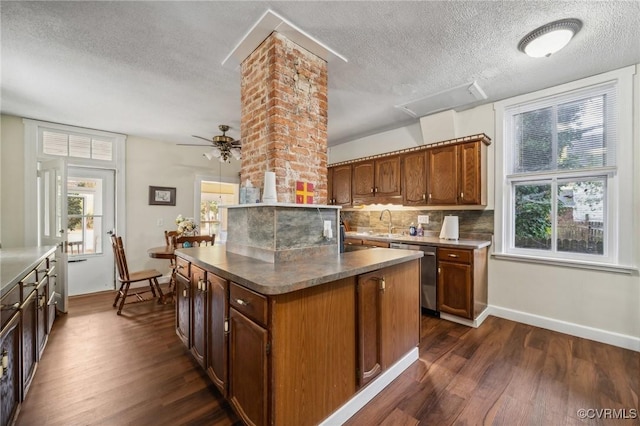 102 Market St, Onancock, VA 23417 - kitchen with dishwasher, a textured ceiling, dark wood-type flooring, and baseboards