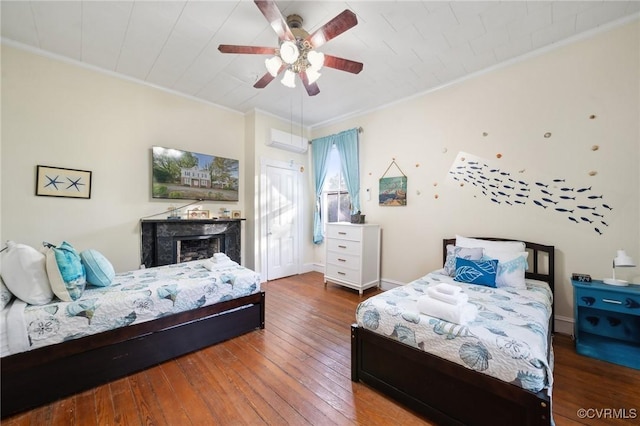 102 Market St, Onancock, VA 23417 - bedroom with wood-type flooring, crown molding, a fireplace, ceiling fan, and baseboards