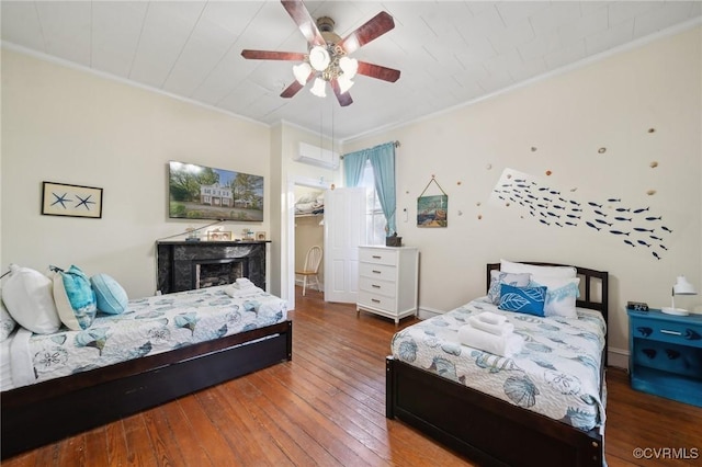 102 Market St, Onancock, VA 23417 - bedroom featuring hardwood / wood-style floors, a fireplace, crown molding, and a ceiling fan
