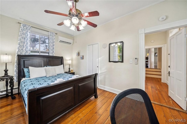 102 Market St, Onancock, VA 23417 - bedroom featuring a wall unit AC, hardwood / wood-style floors, ornamental molding, baseboards, and a baseboard radiator