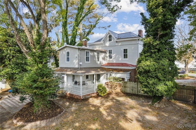 102 Market St, Onancock, VA 23417 - back of property featuring fence, a porch, and a chimney