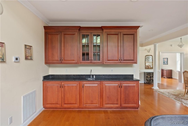 9428 Berry Patch Ln, Mechanicsville, VA 23116 - indoor wet bar with ornate columns, light wood-type flooring, ornamental molding, and baseboards
