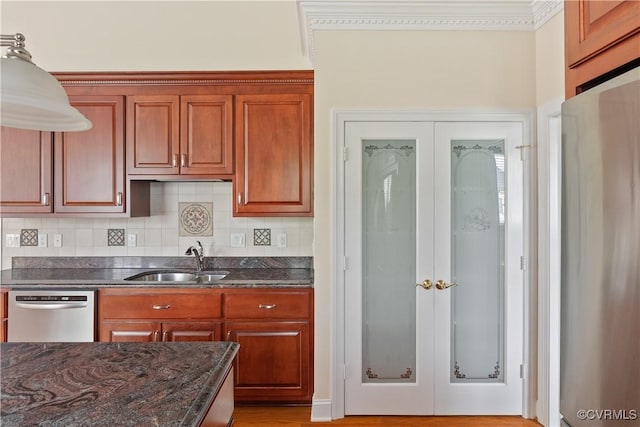 9428 Berry Patch Ln, Mechanicsville, VA 23116 - kitchen with a sink, stainless steel dishwasher, backsplash, dark stone countertops, and brown cabinetry