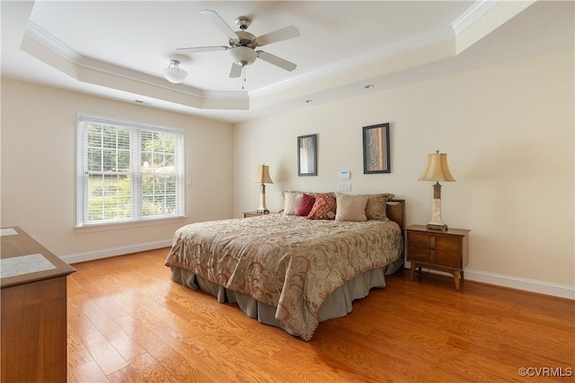 9428 Berry Patch Ln, Mechanicsville, VA 23116 - bedroom featuring a raised ceiling, crown molding, baseboards, light wood-style flooring, and a ceiling fan