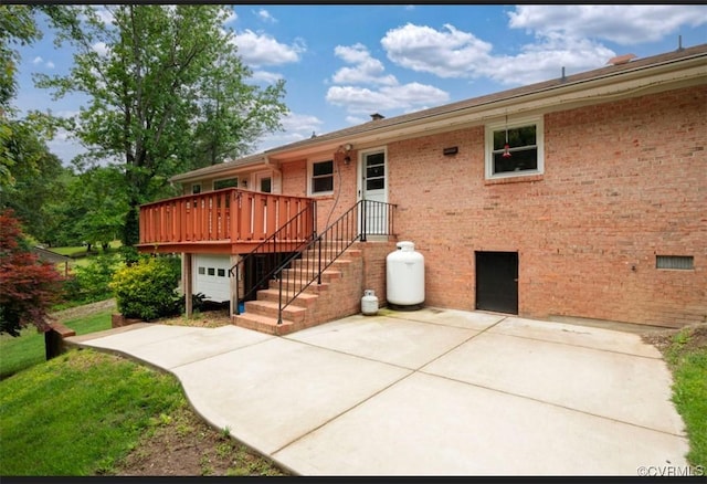 5401 Carteret Rd, Chesterfield, VA 23832 - rear view of house with a patio, a deck, brick siding, and an attached garage