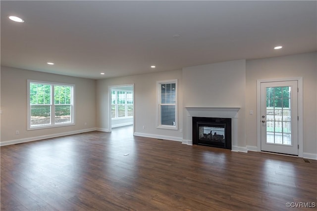 12540 N Readers Ln, Manakin Sabot, VA 23103 - unfurnished living room featuring dark wood-type flooring, a glass covered fireplace, baseboards, and recessed lighting