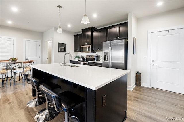 3700 Maze Runner Dr Unit 204, Midlothian, VA 23112 - kitchen with appliances with stainless steel finishes, a sink, recessed lighting, light wood finished floors, and a center island with sink