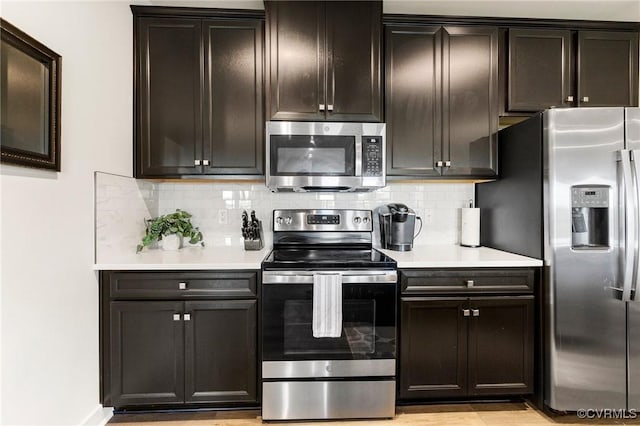 3700 Maze Runner Dr Unit 204, Midlothian, VA 23112 - kitchen featuring appliances with stainless steel finishes, backsplash, light countertops, and light wood-type flooring