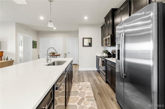 3700 Maze Runner Dr Unit 204, Midlothian, VA 23112 - kitchen featuring stainless steel appliances, a sink, light countertops, light wood-style floors, and recessed lighting